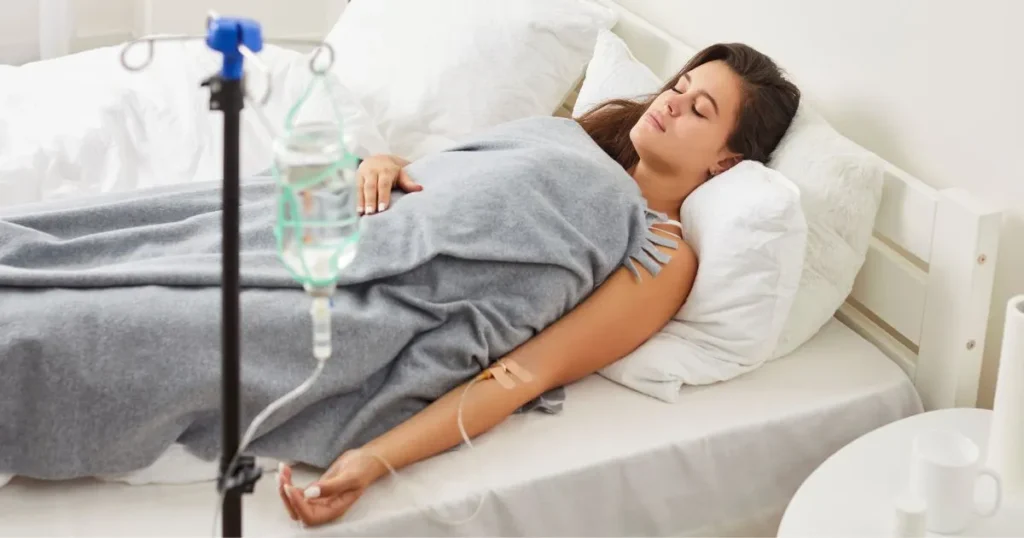 Young woman receiving IV therapy while resting in a comfortable bed in Buford, GA